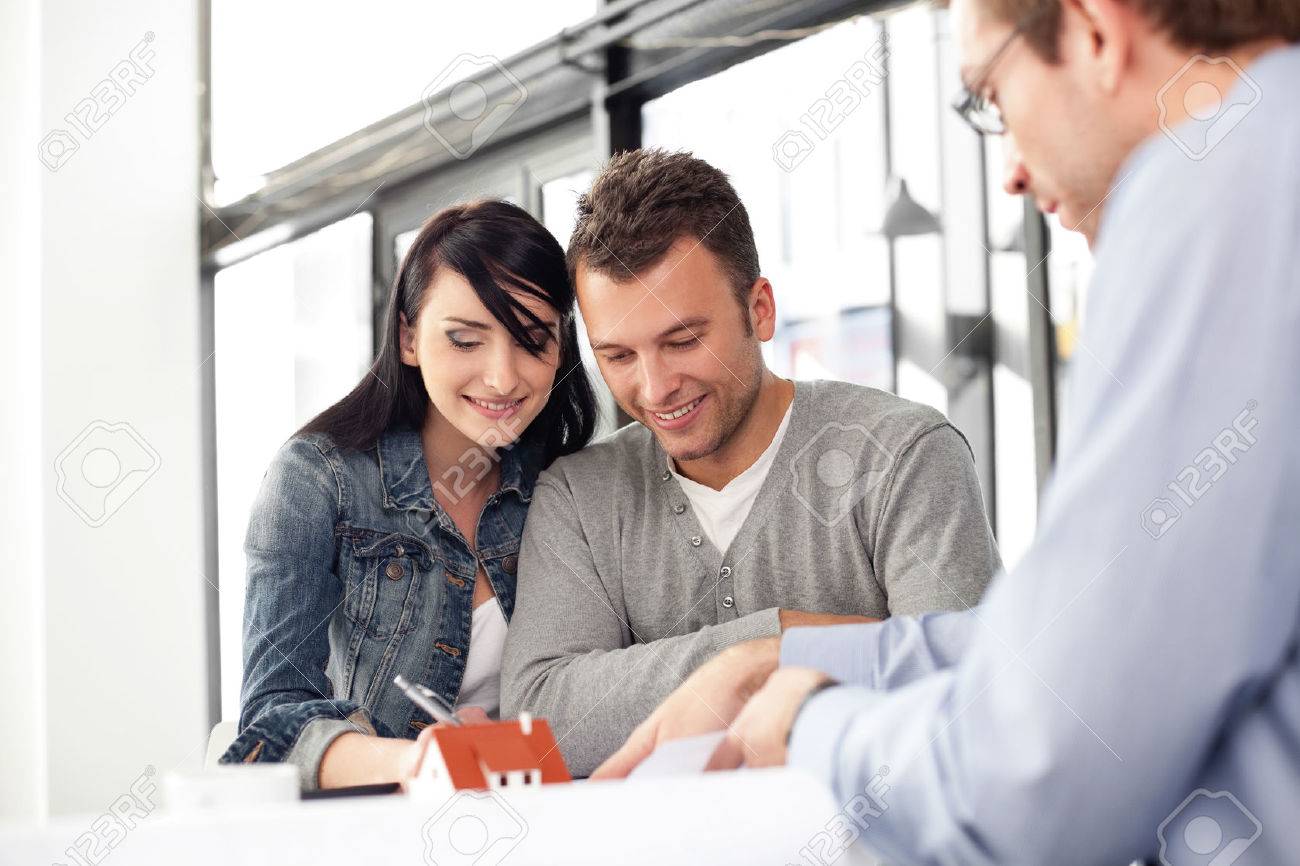 Young couple buying new home. Meeting with architect. - 53952981 Young couple buying new home. Meeting with architect. - 53952981
