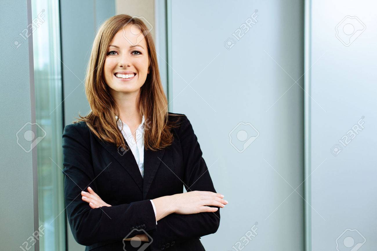 Confident business woman stands in the office - 53954706 Confident business woman stands in the office - 53954706
