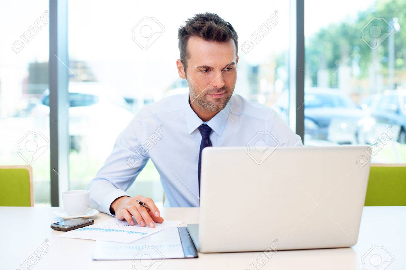 Man Working At The Office On Laptop Stock Photo, Picture And Royalty Free Image. Image 53959238.