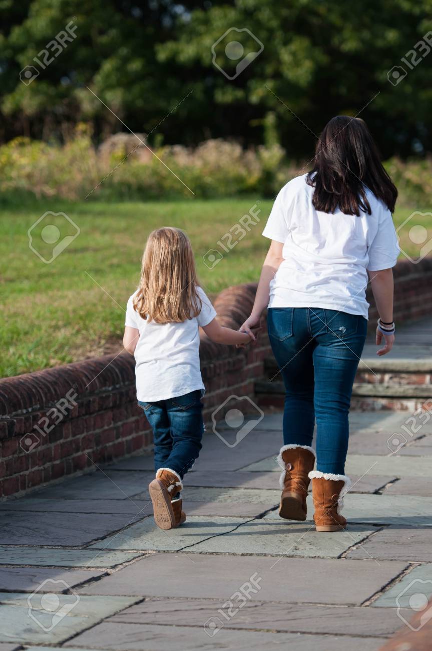 Two Sisters Holding Hands And Walking Together Stock Photo, Picture - 863x1300 - jpeg Two Sisters Holding Hands