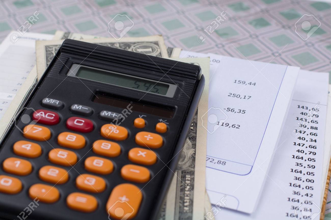 Utility or mortgage bills, calculator and US dollars - finance concept, payments and problems - 66320232 Utility or mortgage bills, calculator and US dollars - finance concept, payments and problems - 66320232
