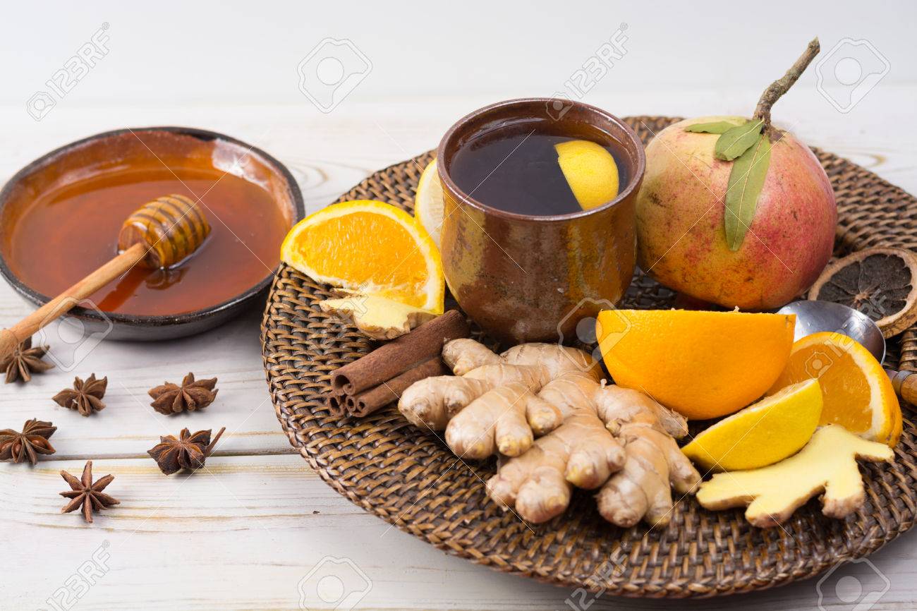 Natural flu and cold remedy - orange and lemon fruit, fresh ginger, honey - alternative medicine, health concept - 66414120 Natural flu and cold remedy - orange and lemon fruit, fresh ginger, honey - alternative medicine, health concept - 66414120