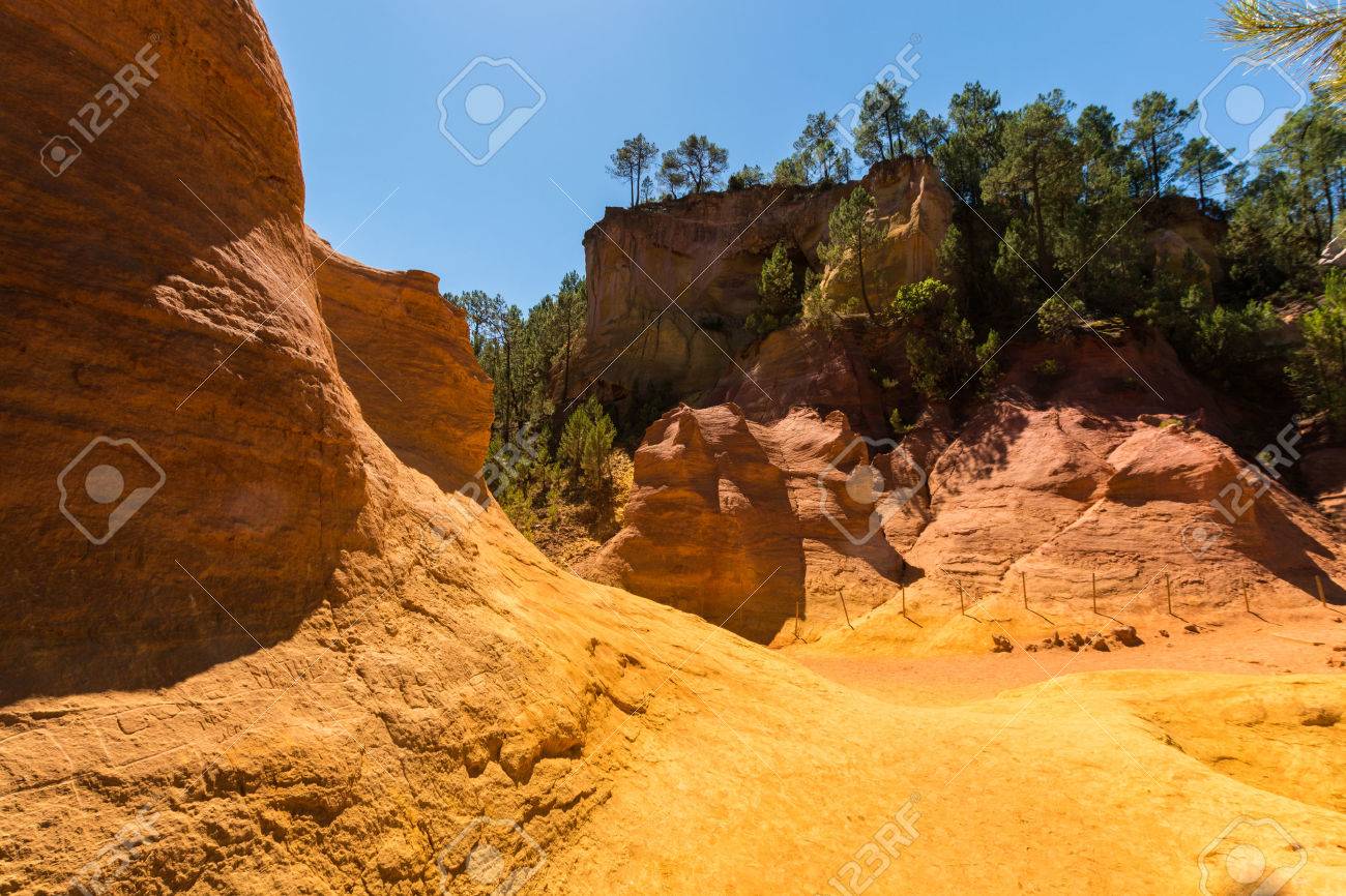 Oragne ochre picturesque hills. Languedoc - Roussillon, Provence, France. Preserve natural dye production - ocher. - 71037506 Oragne ochre picturesque hills. Languedoc - Roussillon, Provence, France. Preserve natural dye production - ocher. - 71037506