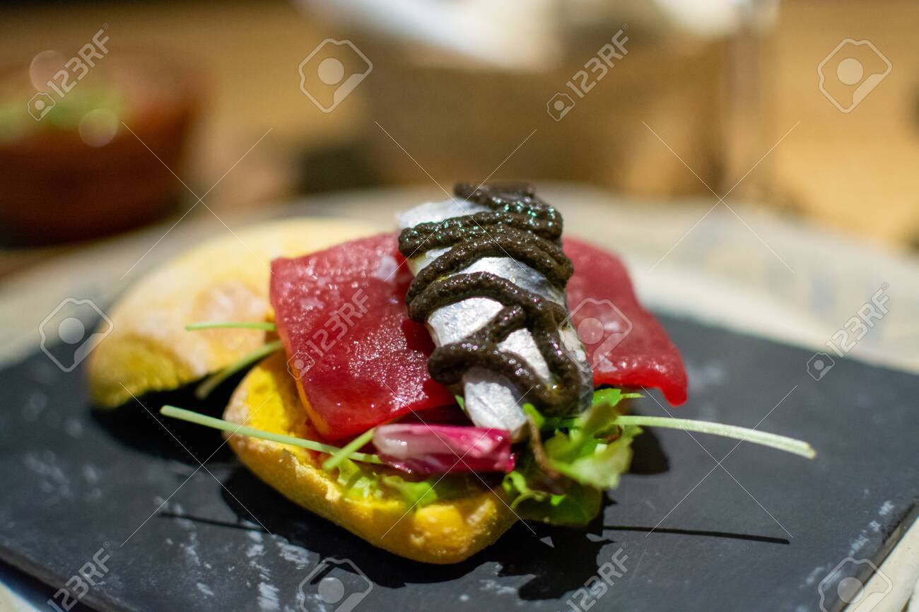Andalusian gourmet food tapas, small curry bread with blue tuna fish and sardine close up - 133359811 Andalusian gourmet food tapas, small curry bread with blue tuna fish and sardine close up - 133359811