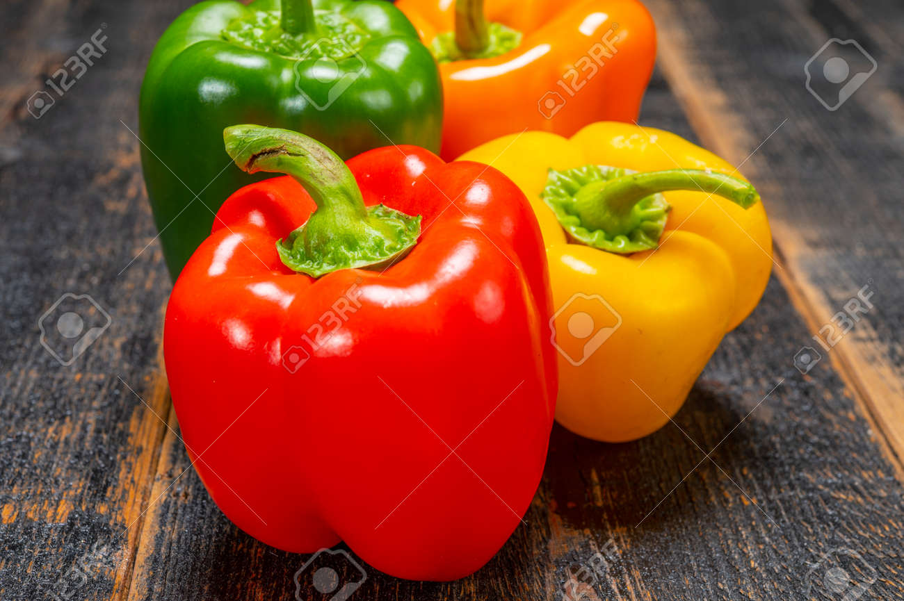 Fresh red, orange, green and yellow sweet bell paprika close up - 143886511 Fresh red, orange, green and yellow sweet bell paprika close up - 143886511