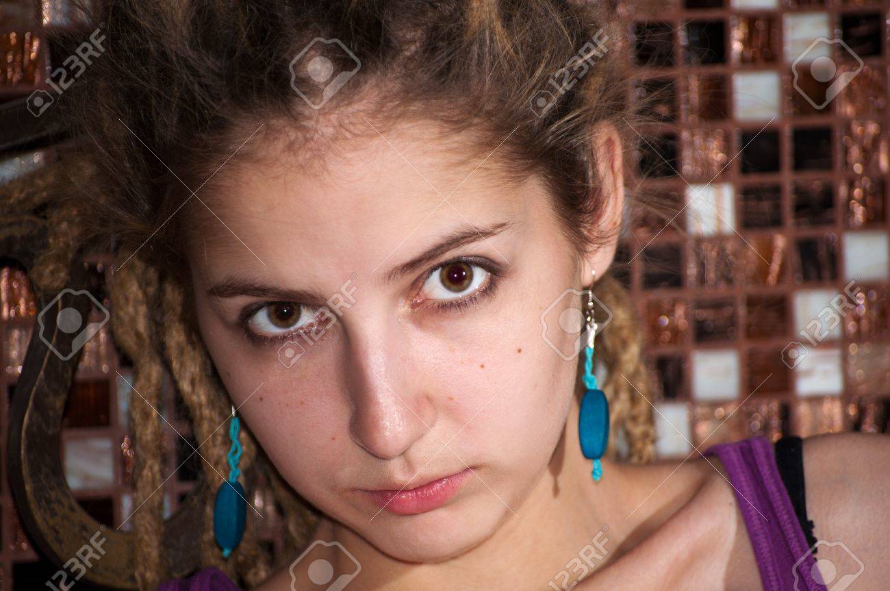 Portrait Of A Young Girl With Dreadlocks On The Background