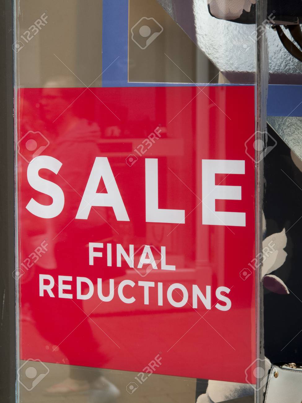 final reductions sale sign in clothing shop window stock photo window sale sign