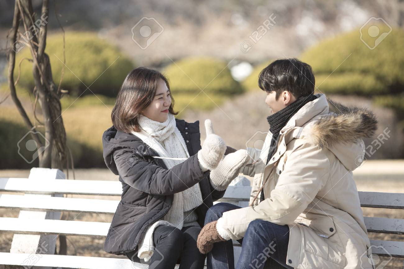 アジア カップル公園でデート 公園でお互いに直面して ベンチに座って の写真素材 画像素材 Image