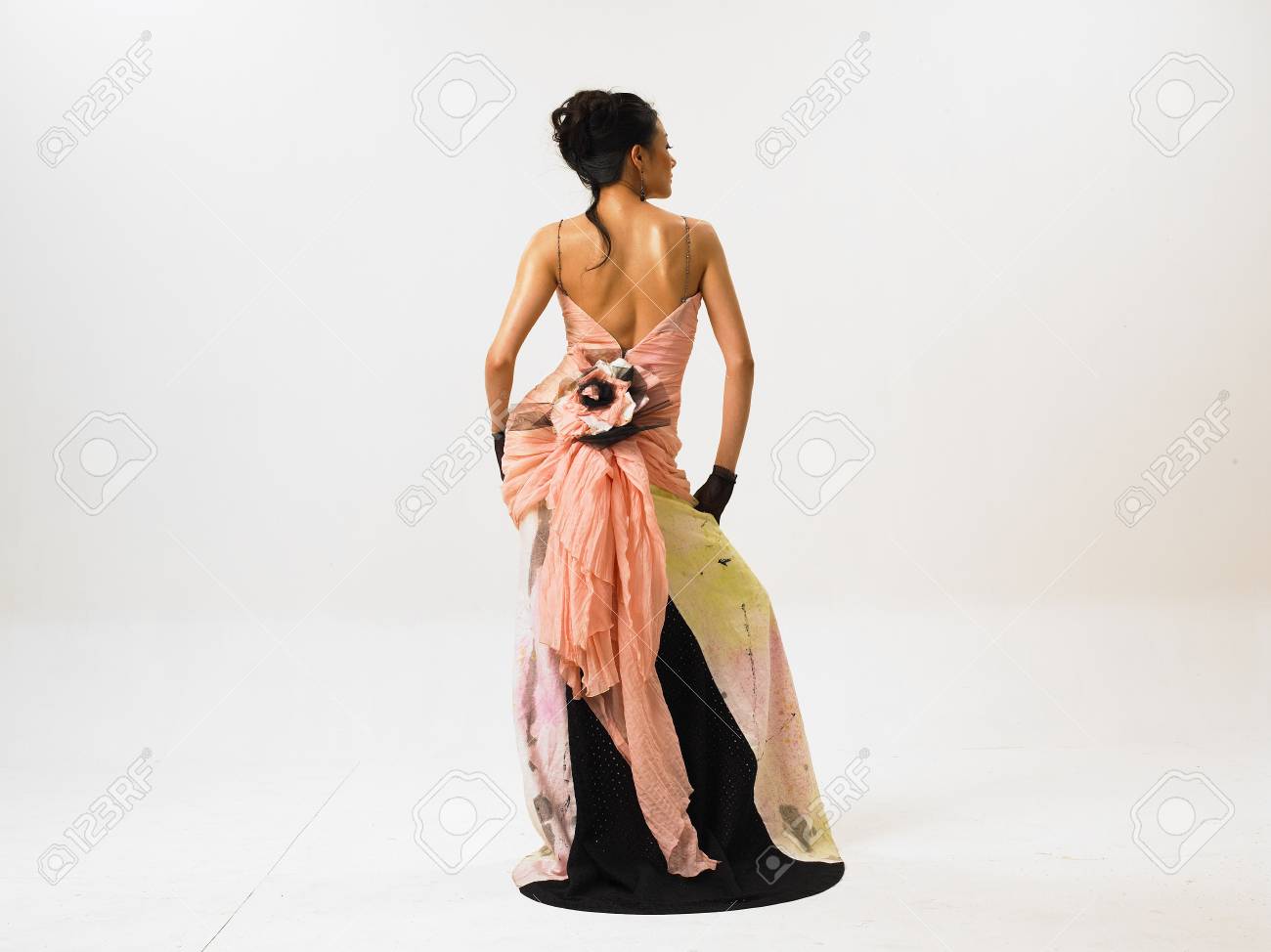 Back Shot Of Asian Woman Fashion Model Posing In A Studio As 