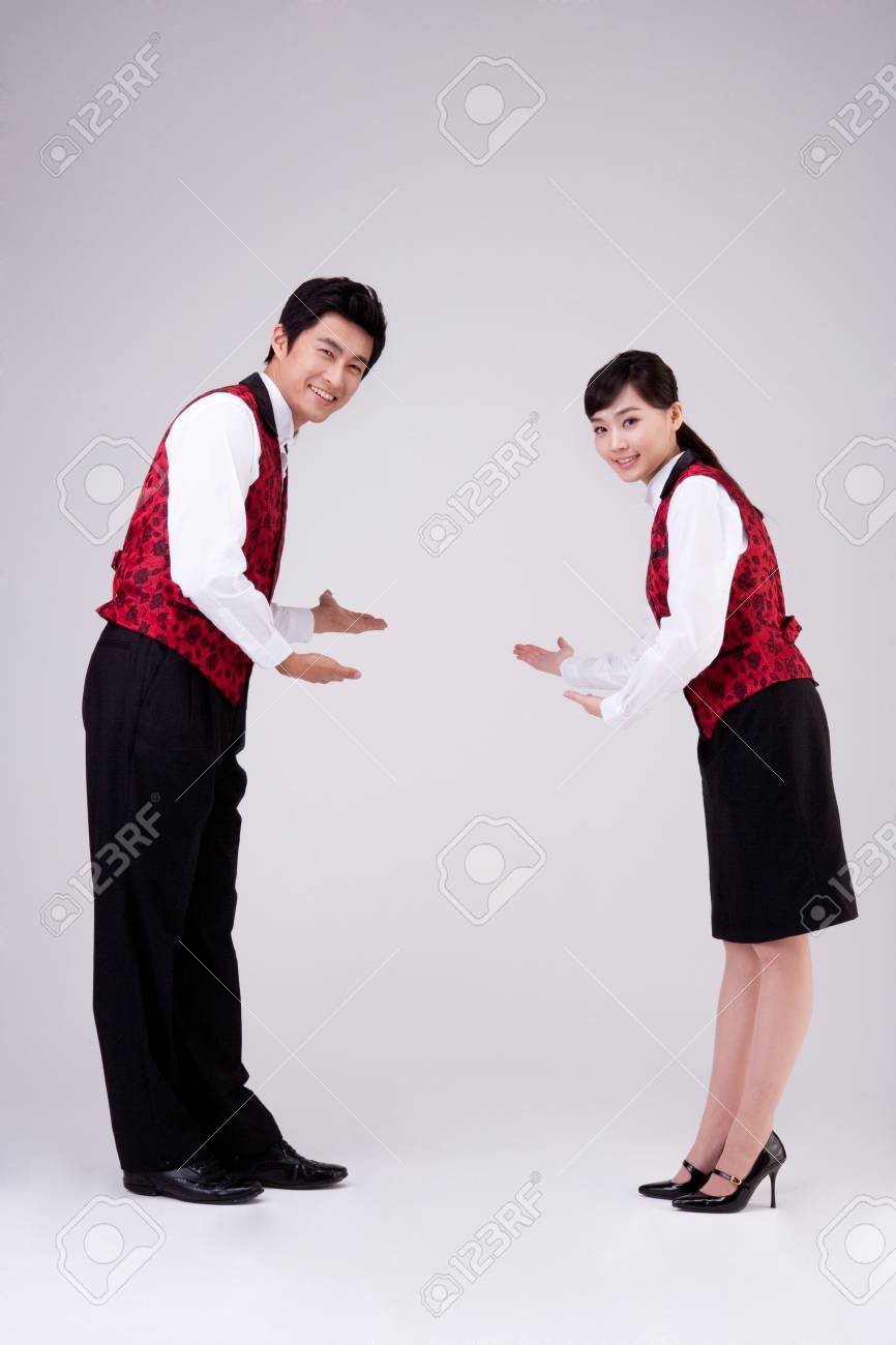 asian restaurant waiter and waitress welcome pose isolated on