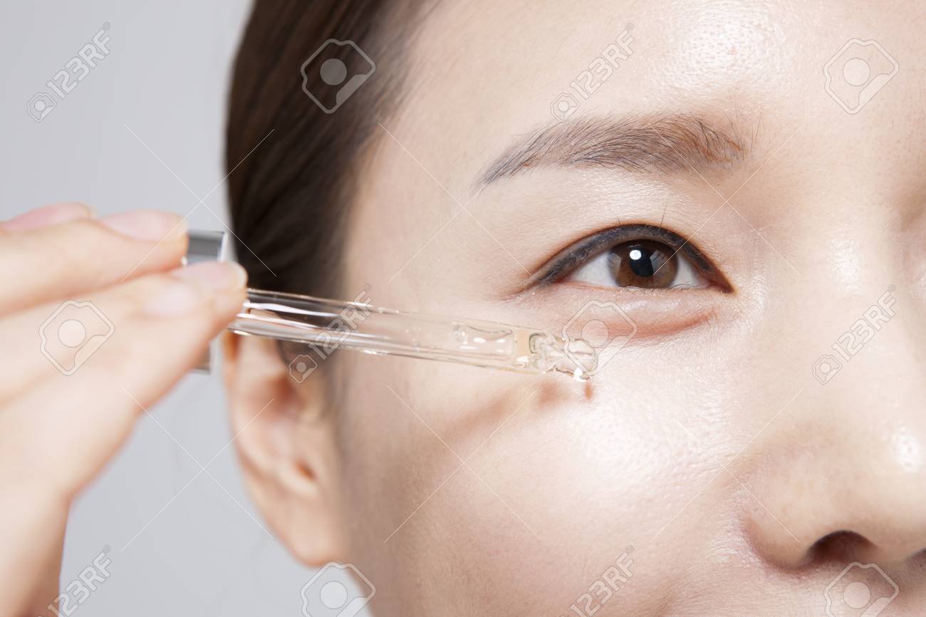 applying serum on face