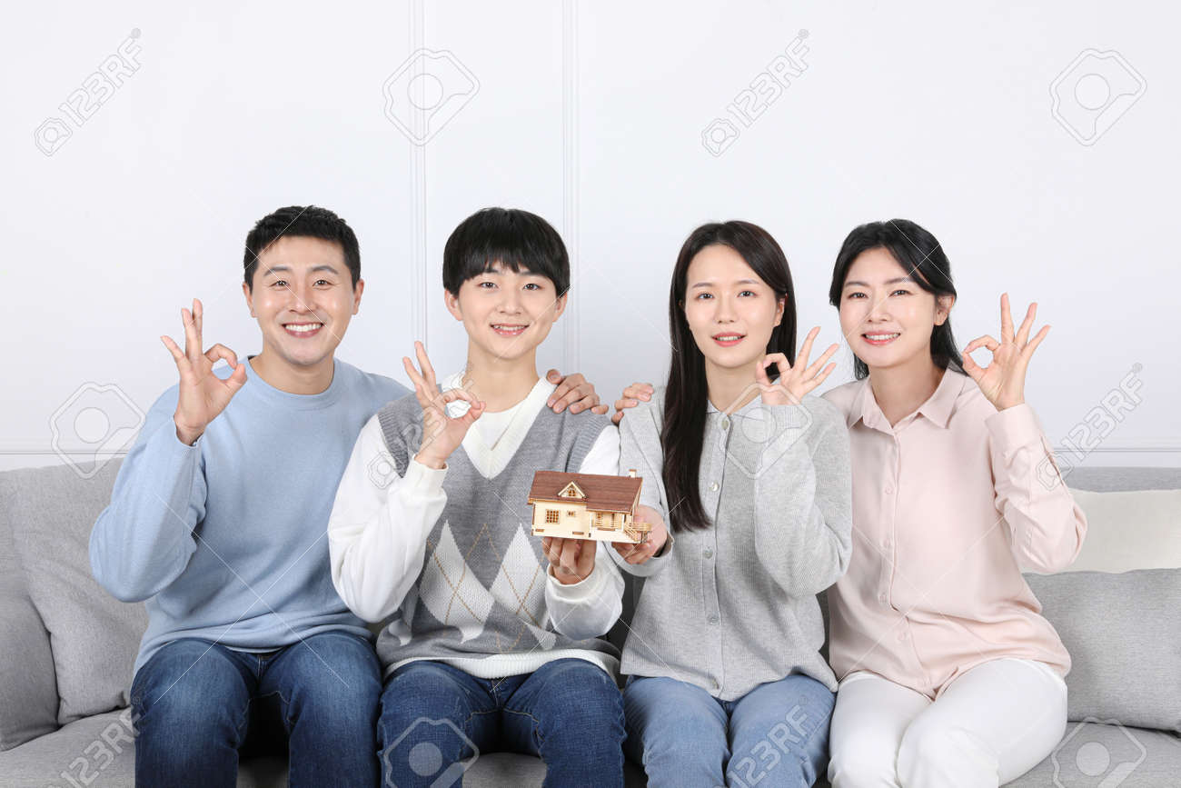 Asian Korean Family_Photo Of A Family Holding A House Model Stock Photo,  Picture and Royalty Free Image. Image 187800763., image size:1300x867