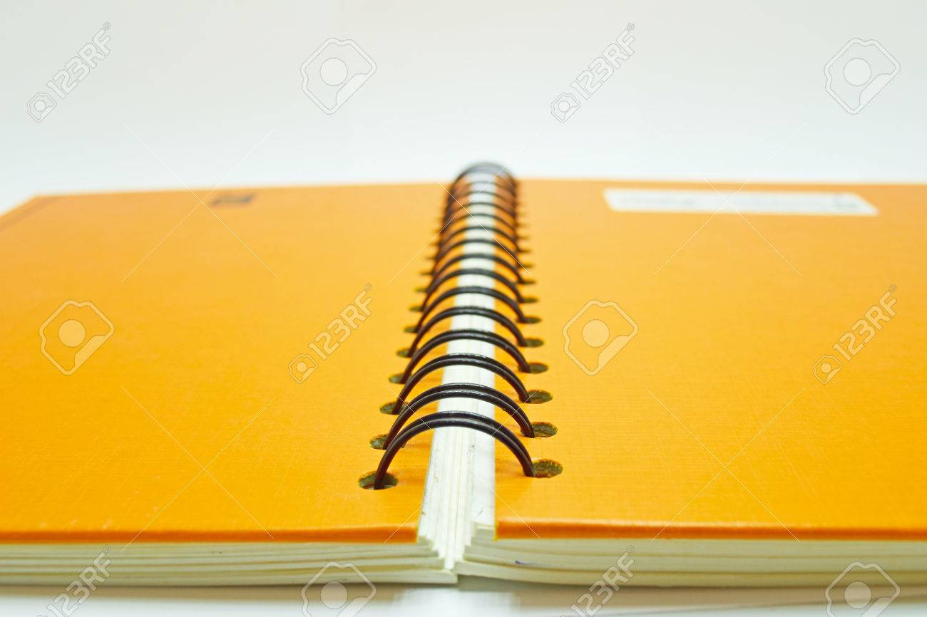close up notebook spine from back side with black and orange stock