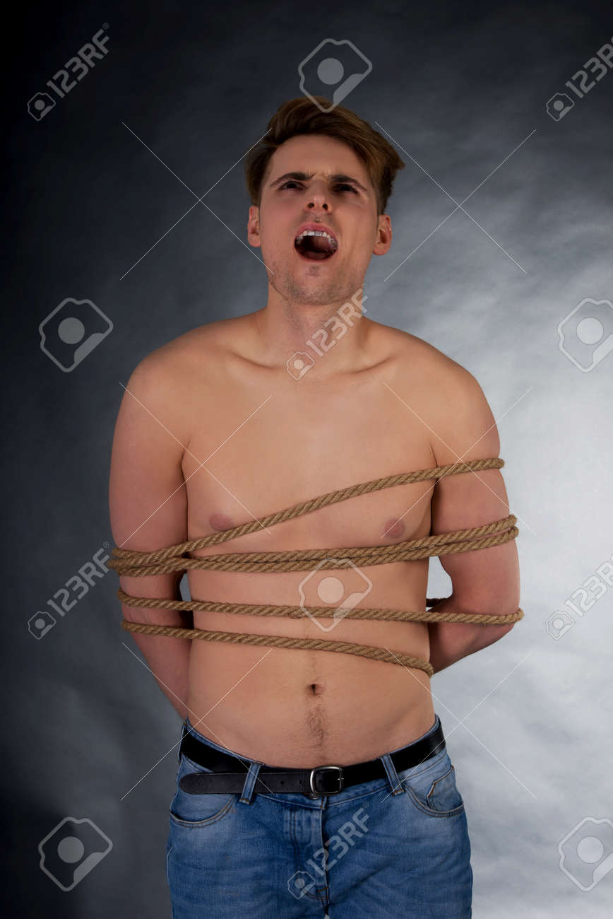 Tortured Shirtless Man Tied With A Rope Stock Photo Picture And Royalty Free Image Image