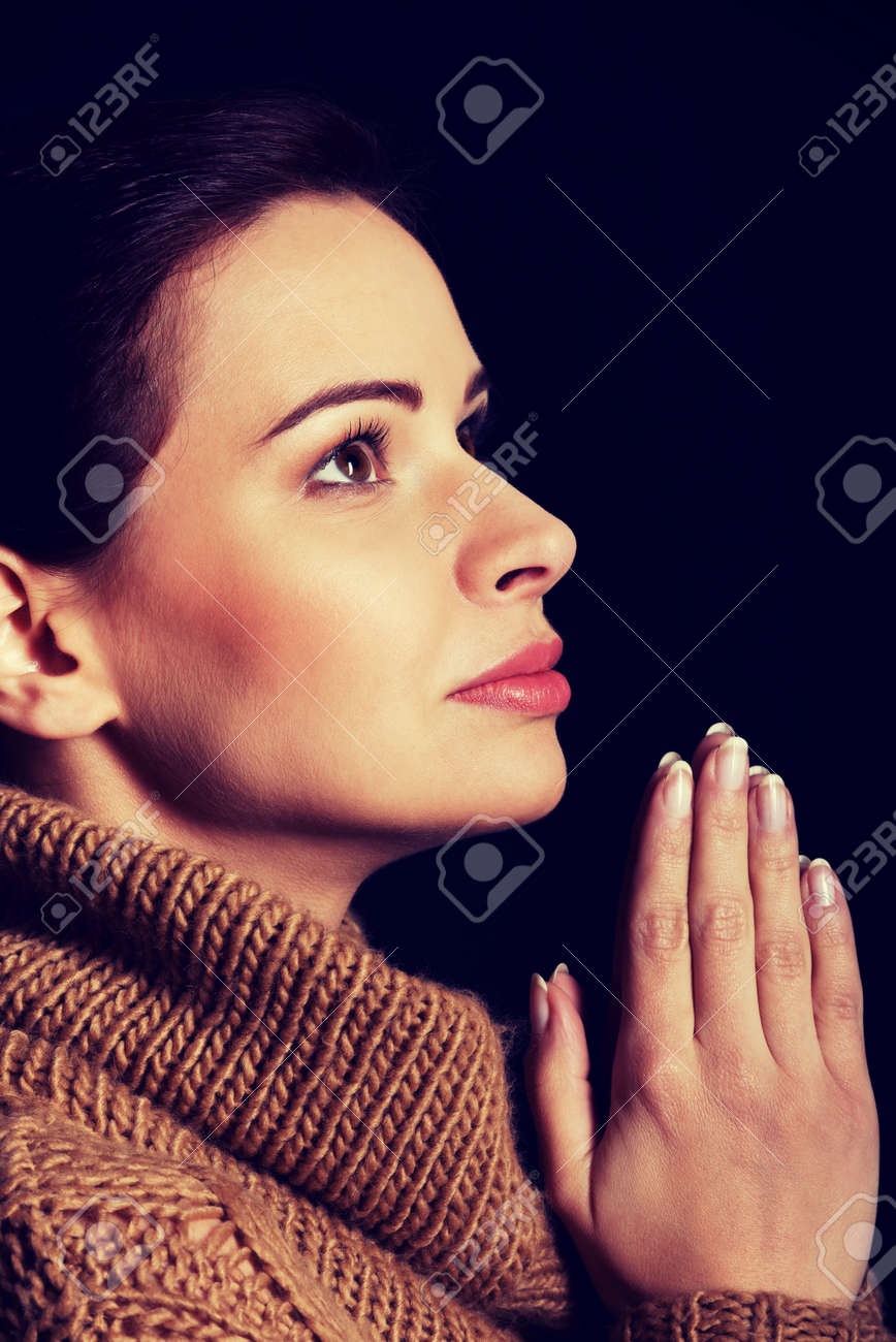 young woman praying over black background stock photo picture and