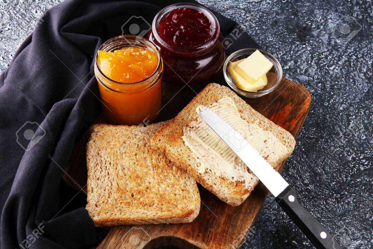 Toast Bread With Homemade Strawberry Jam And Orange Marmalade On Rustic Table Served With Butter For Breakfast Or Brunch Stock Photo Picture And Royalty Free Image Image