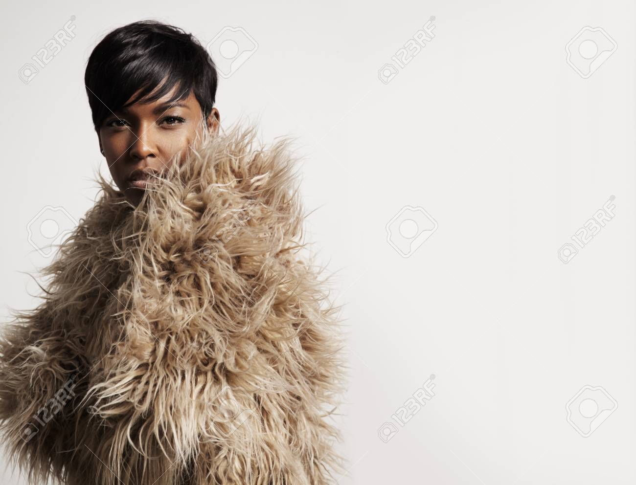 woman wearing a faux fur and watching at camera - 35825212 woman wearing a faux fur and watching at camera - 35825212