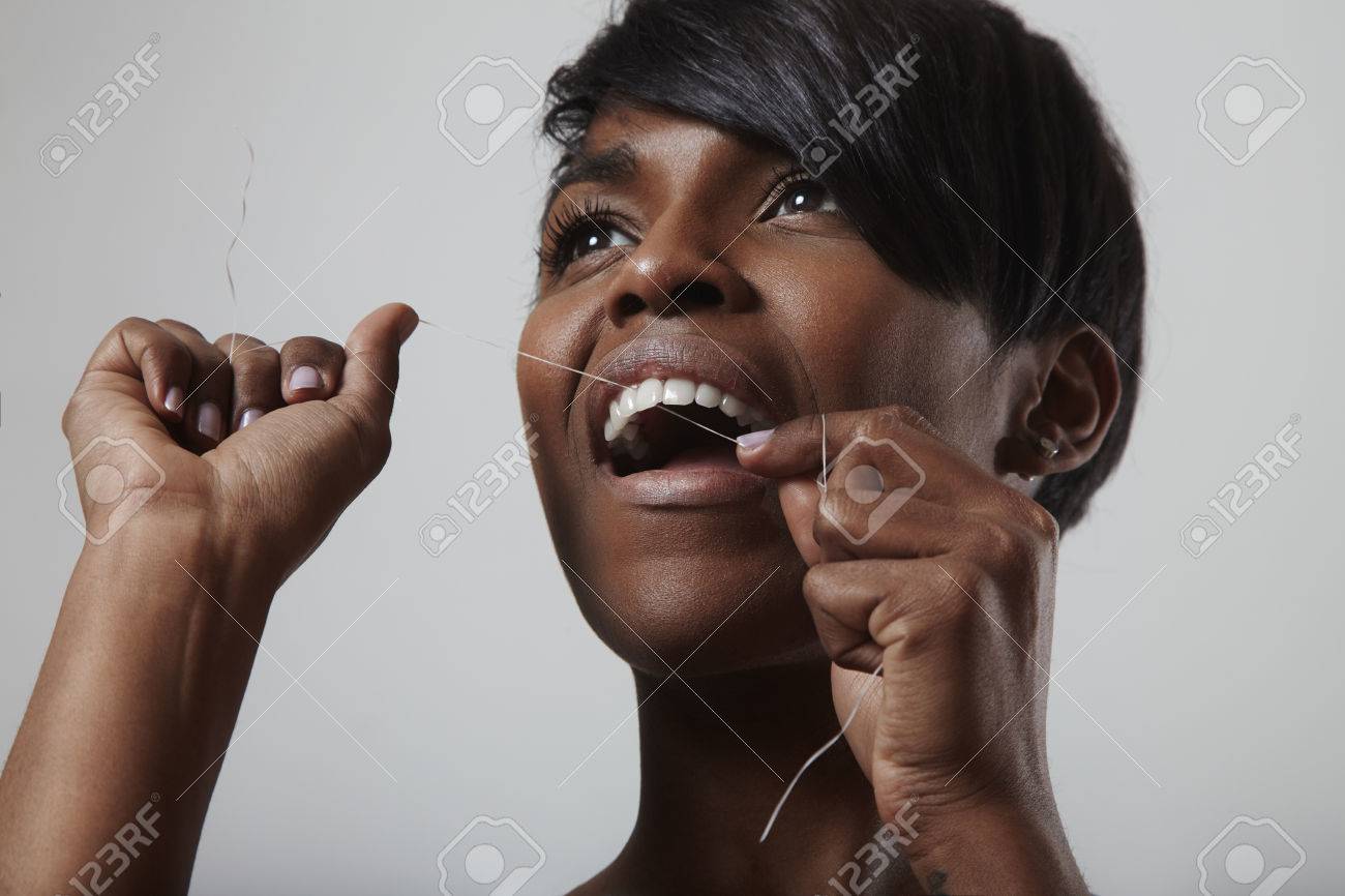 Young woman smiling girl cleaning her white teeth with dental floss - 38272968 Young woman smiling girl cleaning her white teeth with dental floss - 38272968