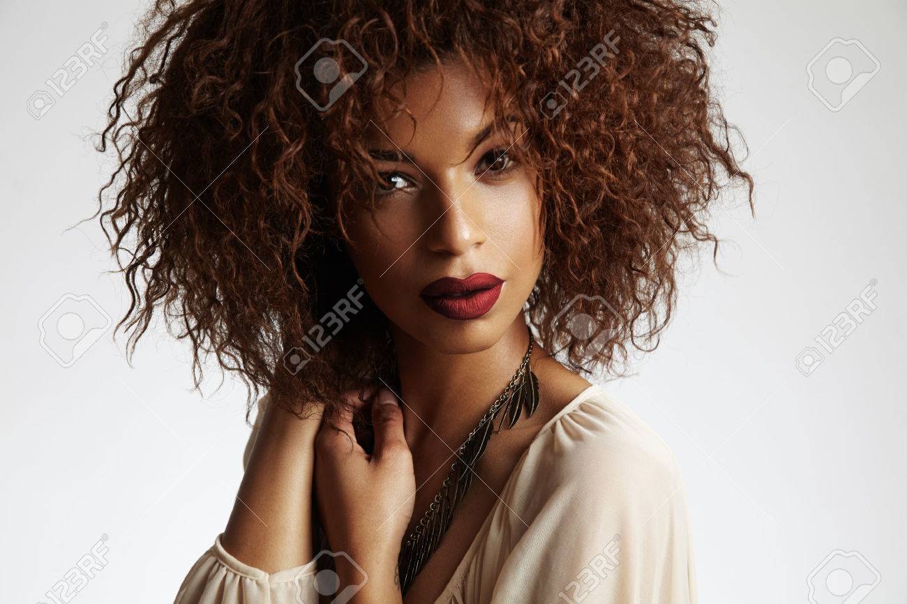 Beauty Black Woman With A Curly Hair And Red Lips Stock Photo