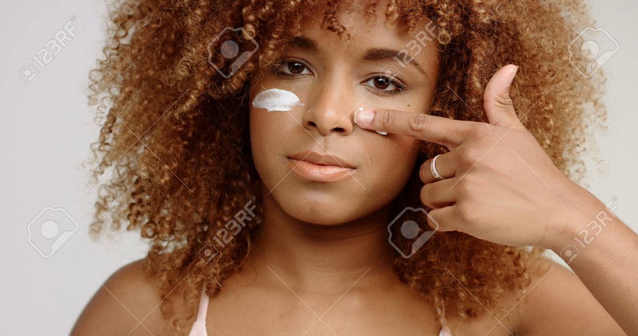 Mixed Race Black Woman With Blonde Curly Hair In Studio With Stock