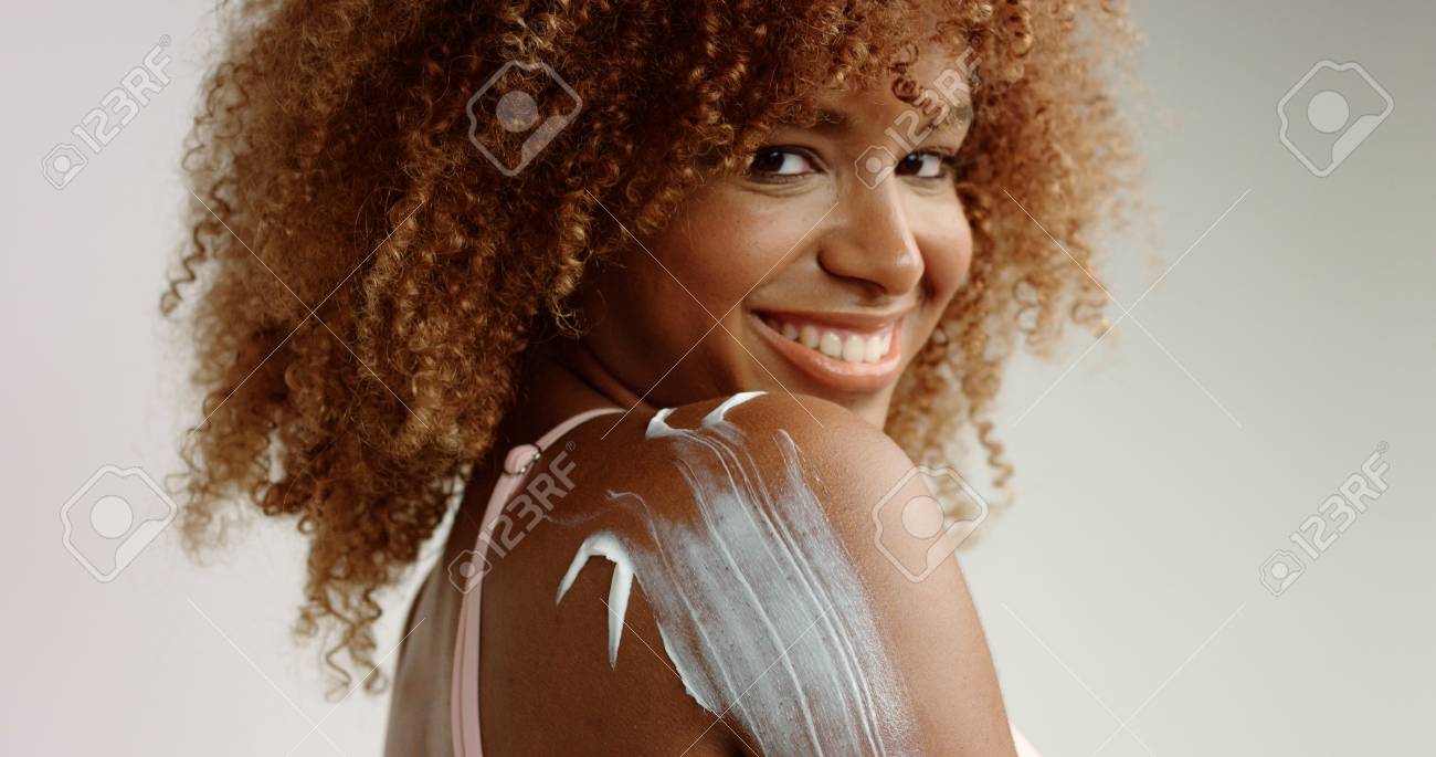 Mixed Race Black Woman With Blonde Curly Hair In Studio With Stock