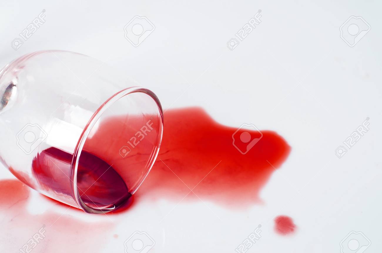 spilled red wine glass isolated on white background stock photo