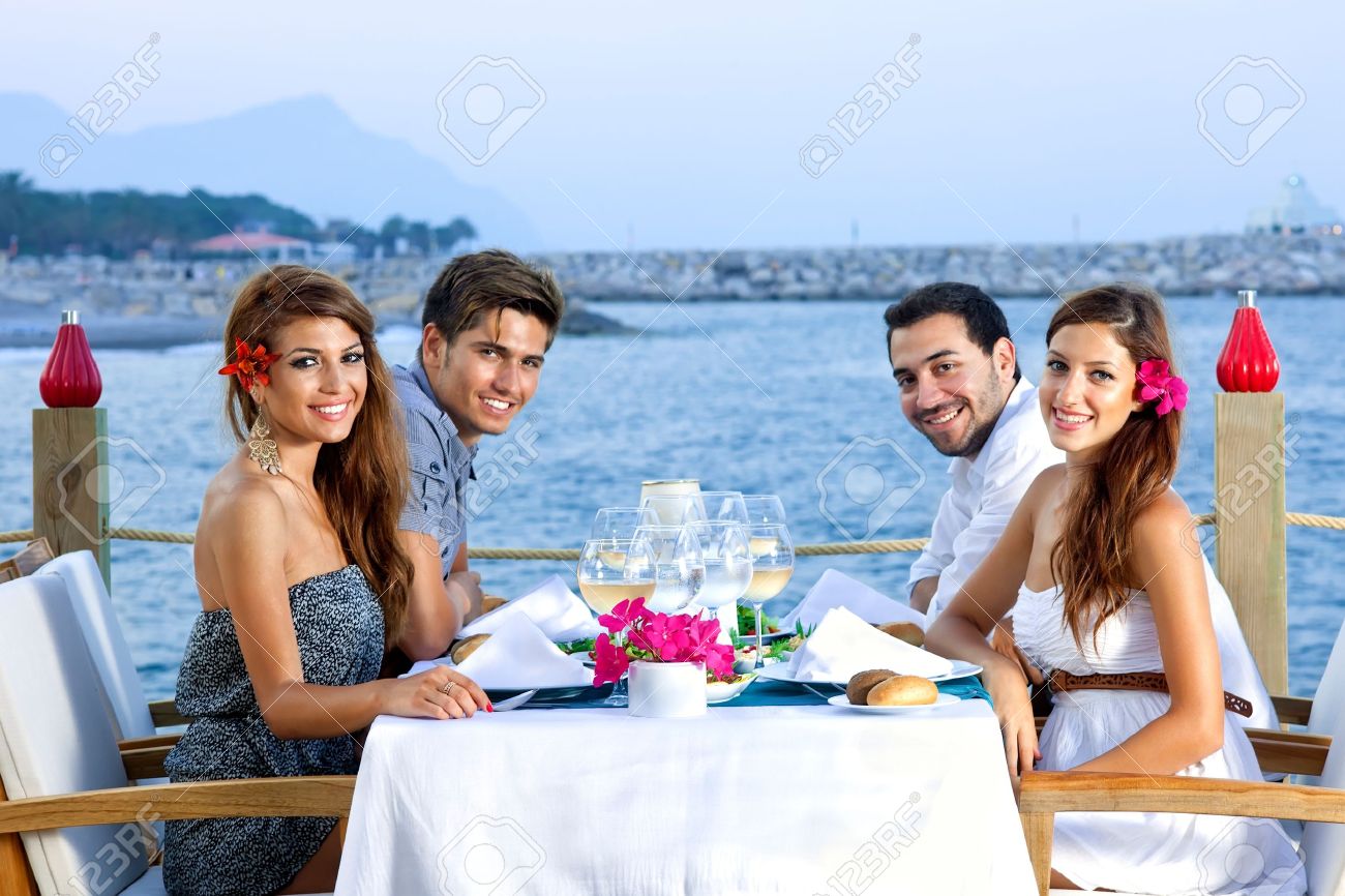 Two Happy Couples Having Dinner At A Fancy Restaurant At The Seaside Stock  Photo, Picture And Royalty Free Image. Image 21500272.
