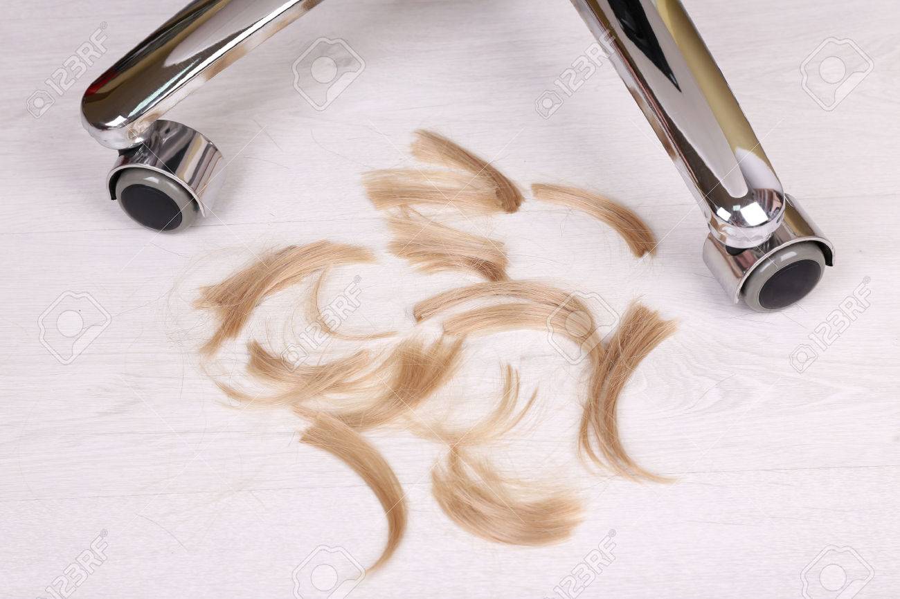 Cut Hair On The Floor In Hairdressing Salon Close Up Stock Photo