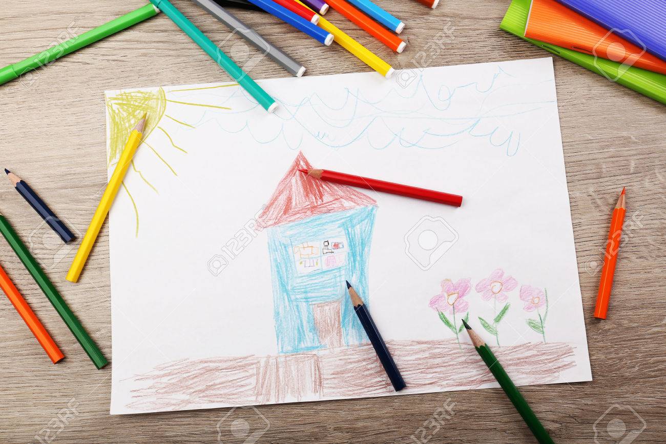 kids drawing on white sheet of paper with crayons and markers