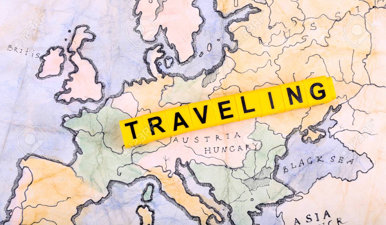 word traveling on world map background stock photo picture and
