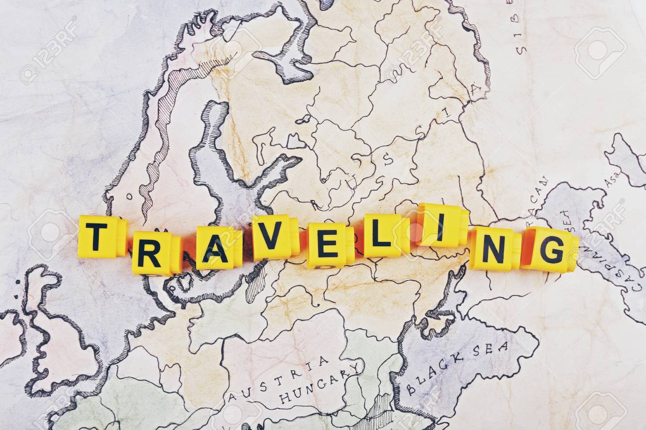 word traveling on world map background stock photo picture and