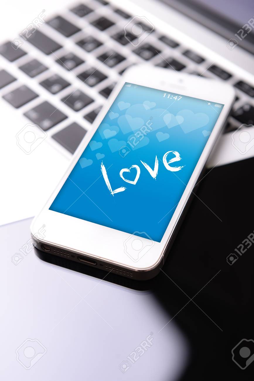 tablet and mobile phone with romantic screensaver on keyboard stock photo picture and royalty free image image 51702773