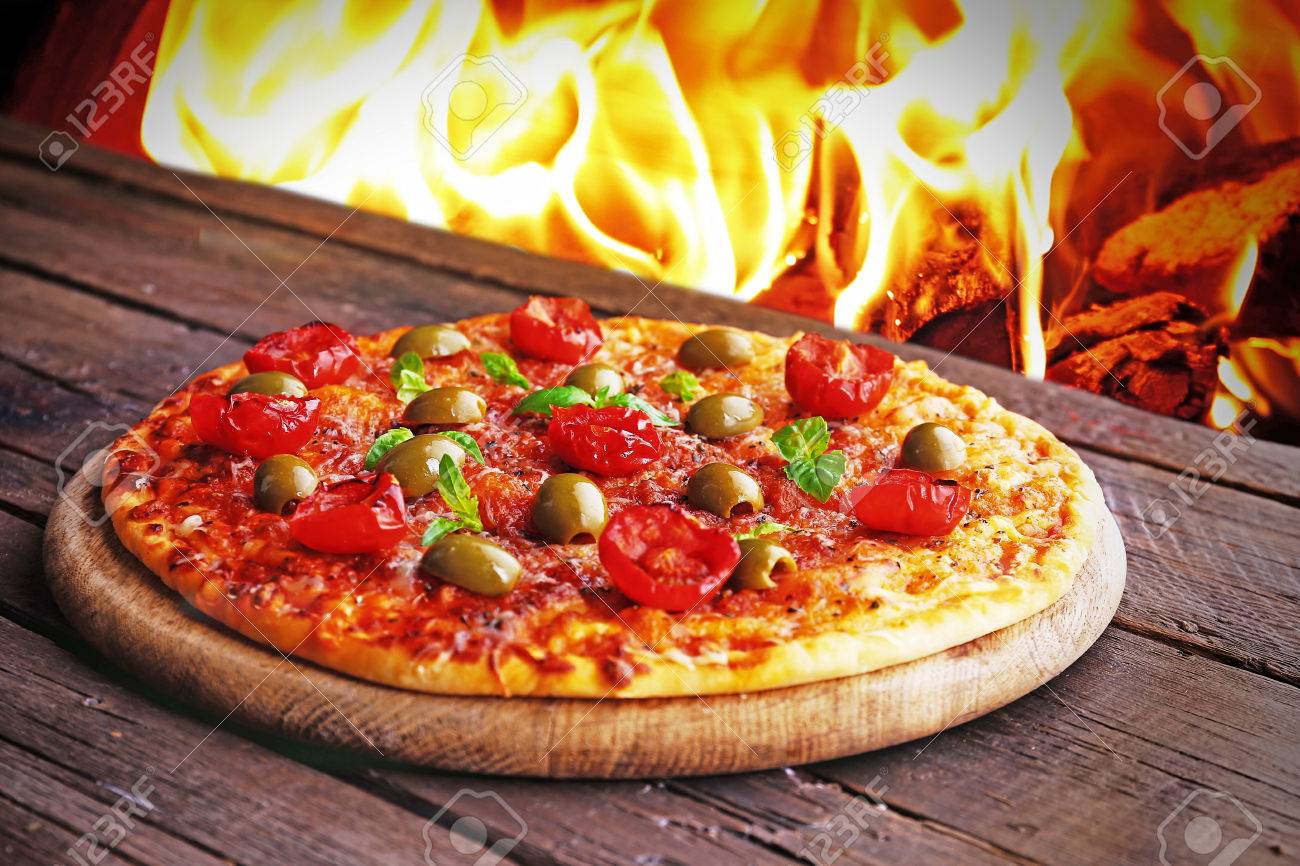Tasty Hot Pizza With Cherry Tomatoes On Wooden Table On Fire Flame Background Stock Photo Picture And Royalty Free Image Image 56814709