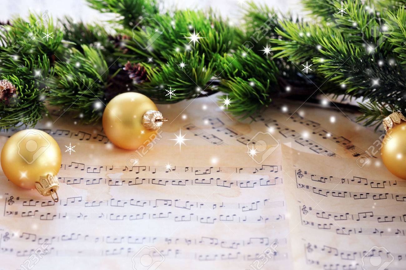 Christmas decorations on music sheets with snow effect - 57510347 Christmas decorations on music sheets with snow effect - 57510347