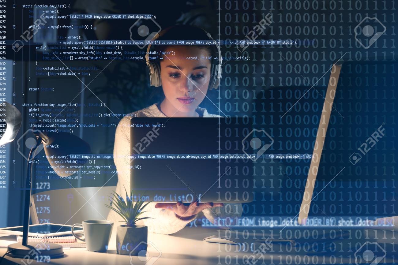 Program development concept. Young woman listening to music while working with laptop - 95548722 Program development concept. Young woman listening to music while working with laptop - 95548722
