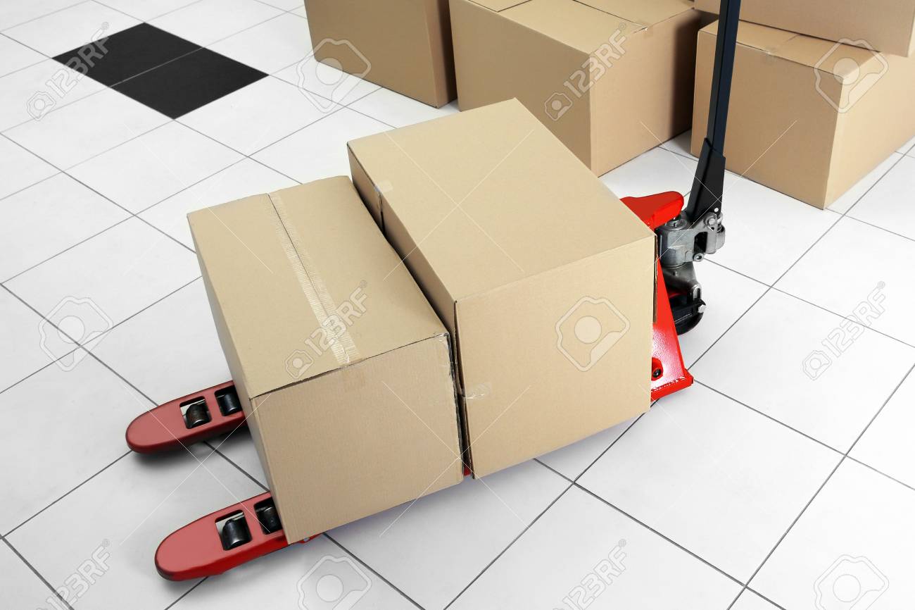 Manual pallet truck with carton boxes indoors Stock Photo - 95959064