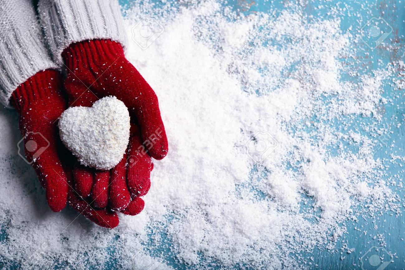 Female hands in mittens with decorative heart on snow background - 95473664 Female hands in mittens with decorative heart on snow background - 95473664