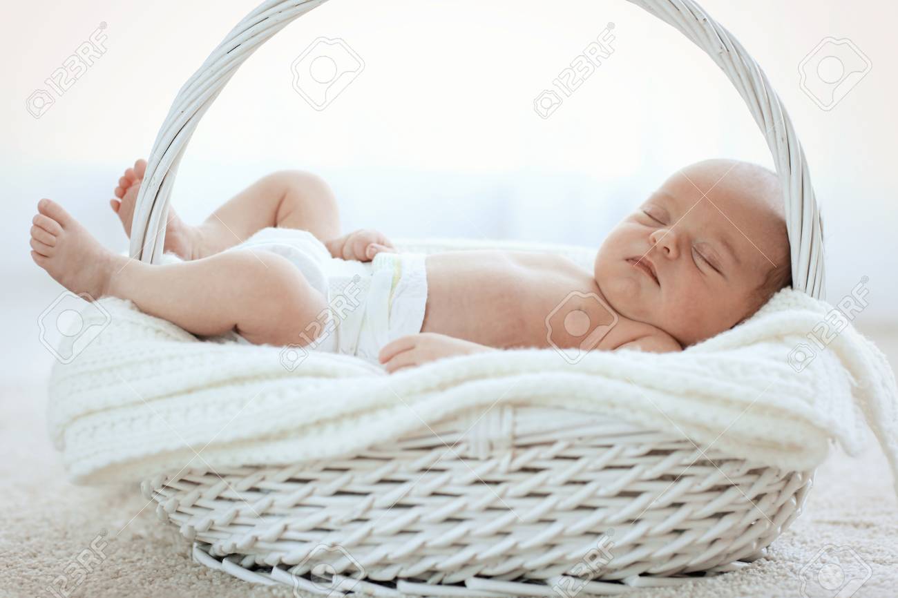 newborn baby girl 7 days old sleeping on soft blanket in a stock