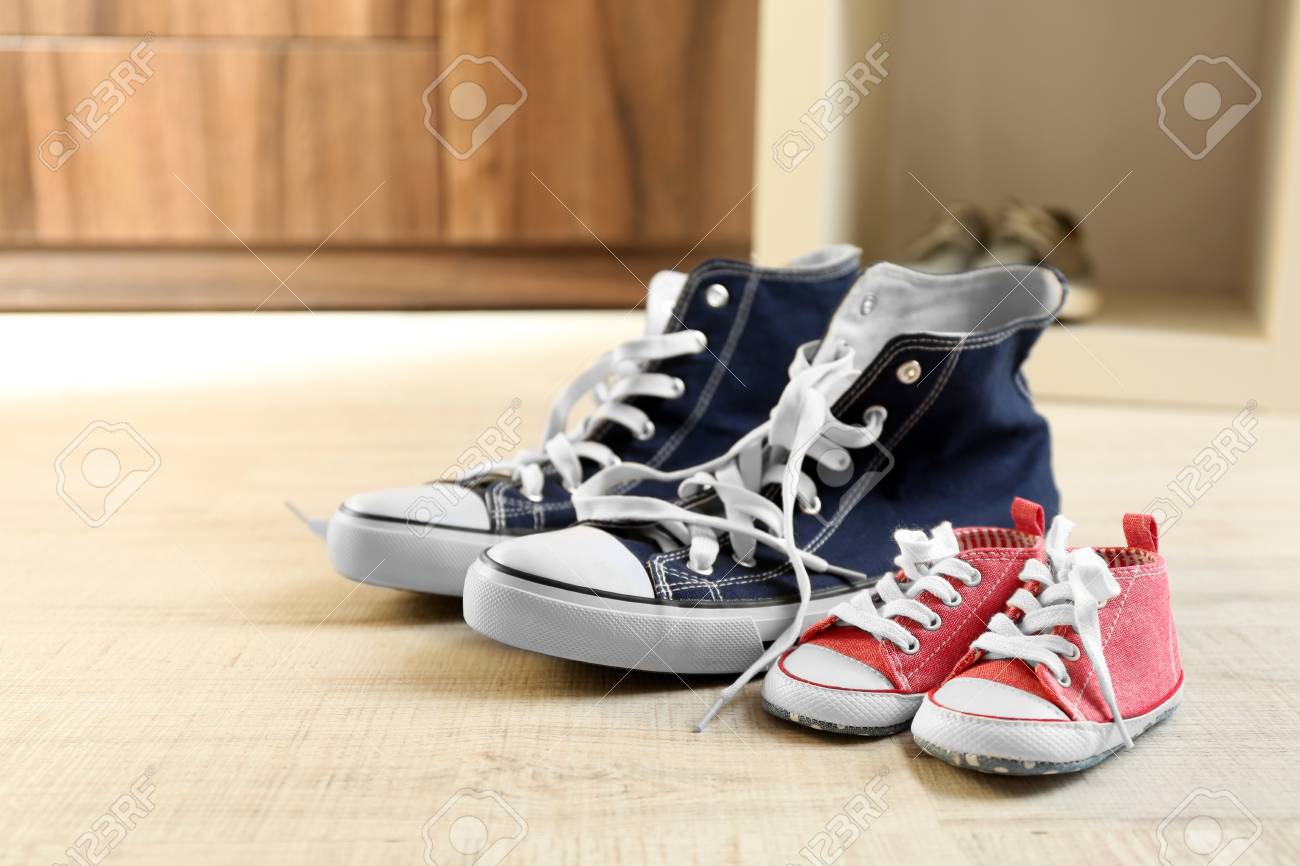 Small Shoes On Wooden Floor Stock Photo 