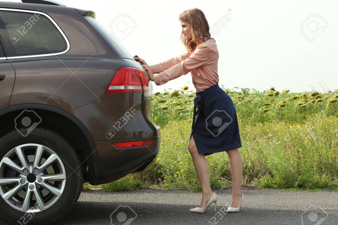 pretty young woman pushing car stock photo picture and royalty free