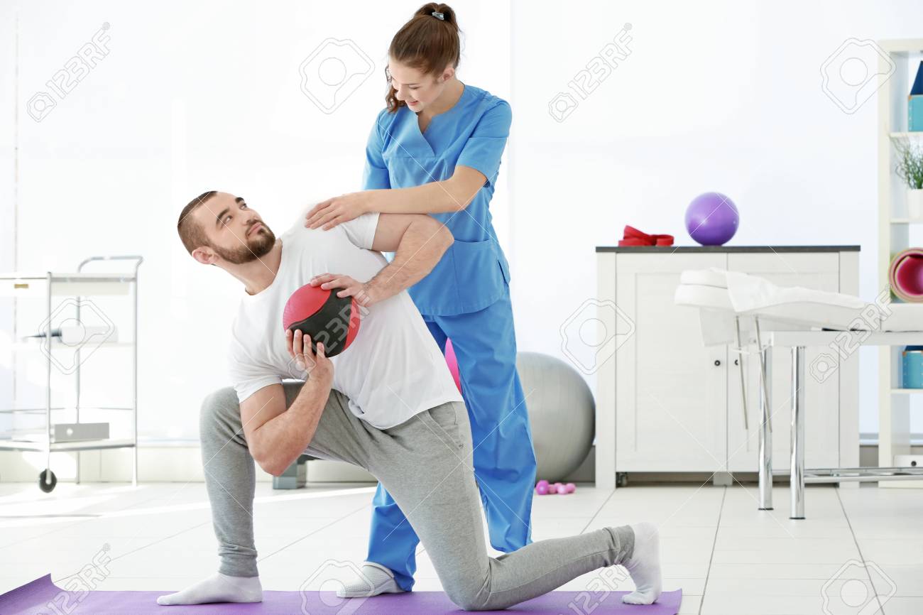 Physiotherapist Working With Patient In Clinic Stock Photo, Picture And  Royalty Free Image. Image 97653863.