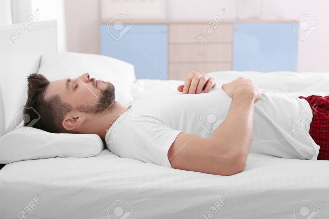 Young Man Lying On Bed With Orthopedic Pillow At Home Stock Photo Picture And Royalty Free Image Image 98033192