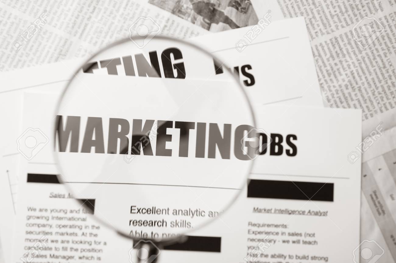 paper sheet with word marketing through magnifier closeup word poto