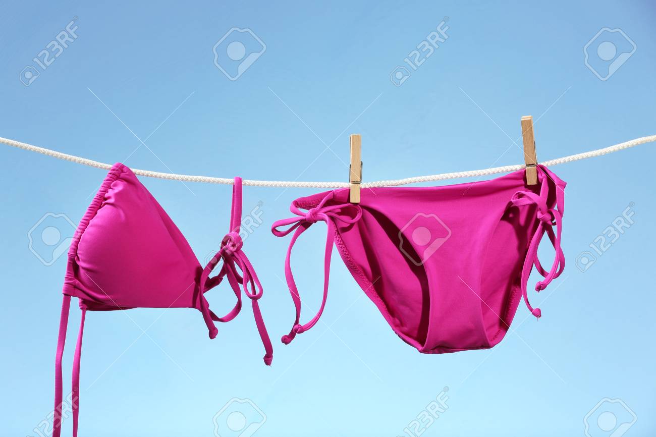 Bikini Light Color Hanging On Rope Background Against Bright eE9IbDYHW2