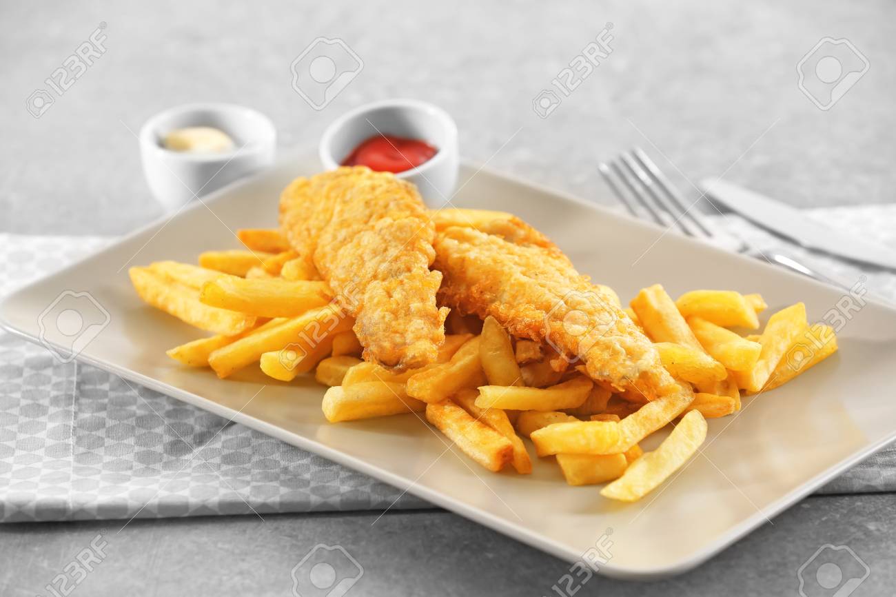 Plate With Tasty Fried Fish And Chips On Table Stock Photo, Picture And Royalty Free Image. Image 98077380.