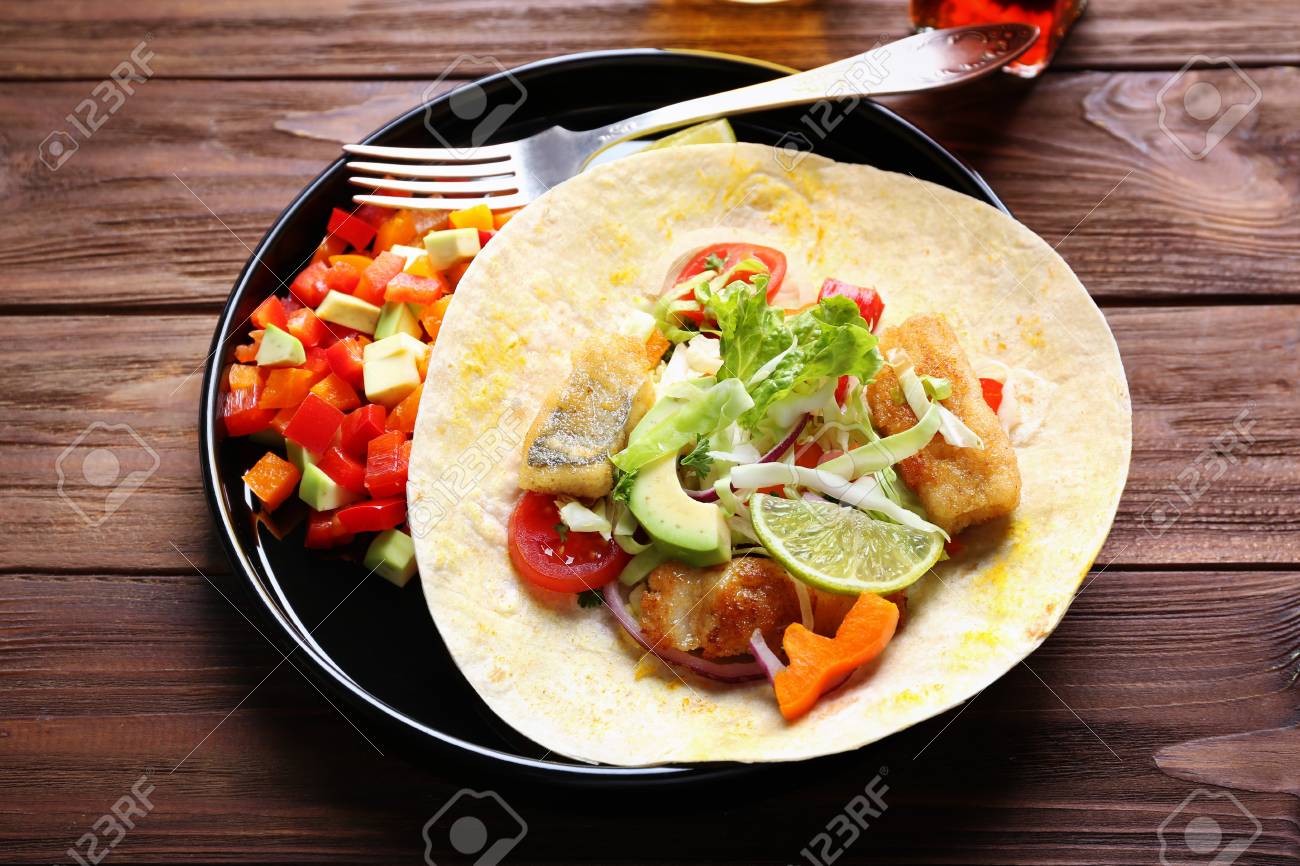 Plate With Tasty Fish Taco And Salad On Wooden Table Stock Photo Picture And Royalty Free Image Image 98088163