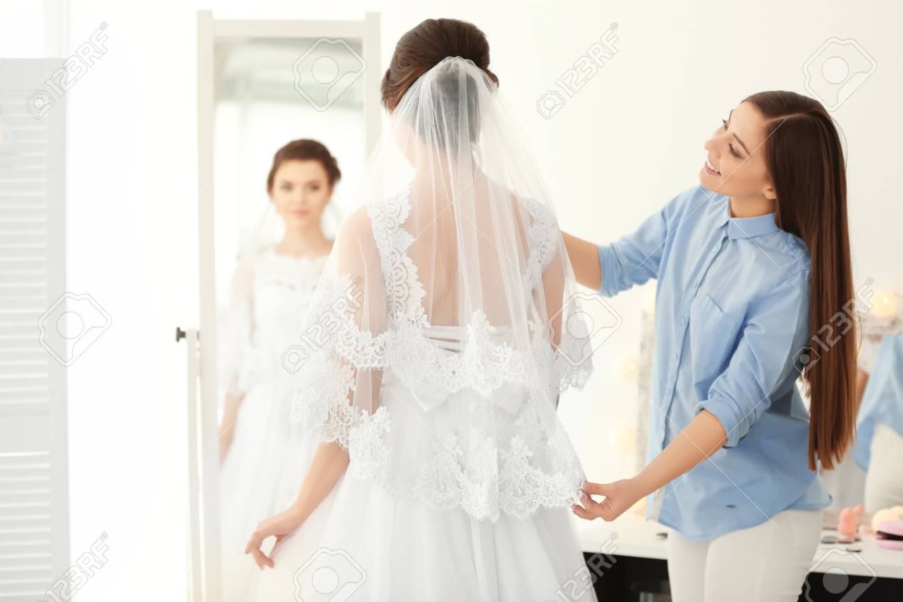 Fashion Stylist Preparing Bride Before Her Wedding In Room Stock Photo Picture And Royalty Free Image Image