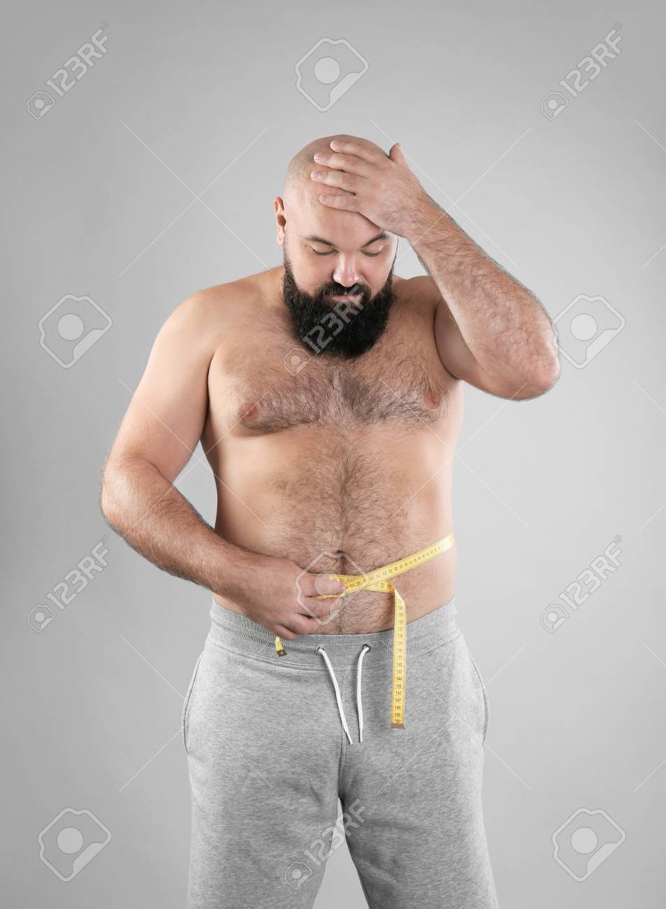Fat Man With Measuring Tape On Grey