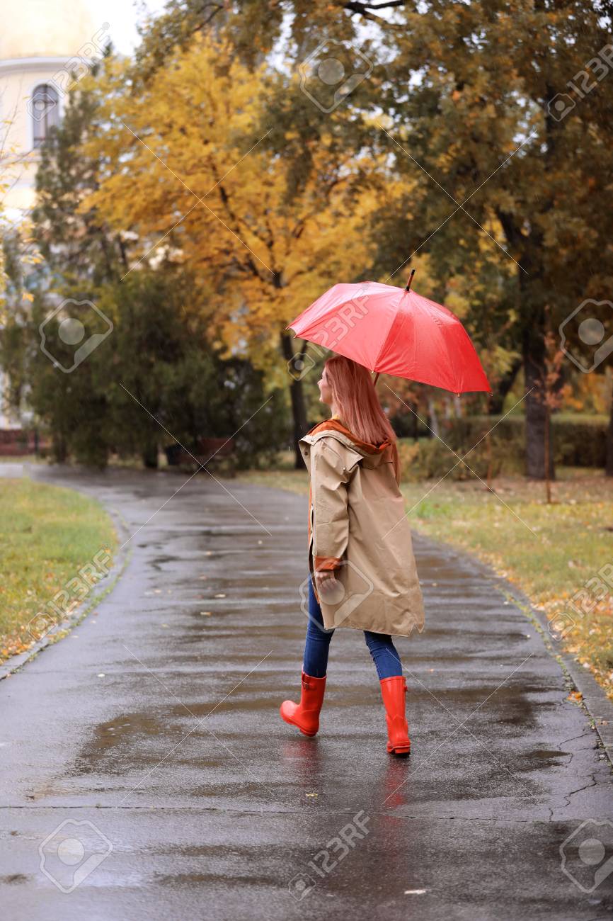 Woman With Umbrella Taking Walk In Autumn Park On Rainy Day Stock