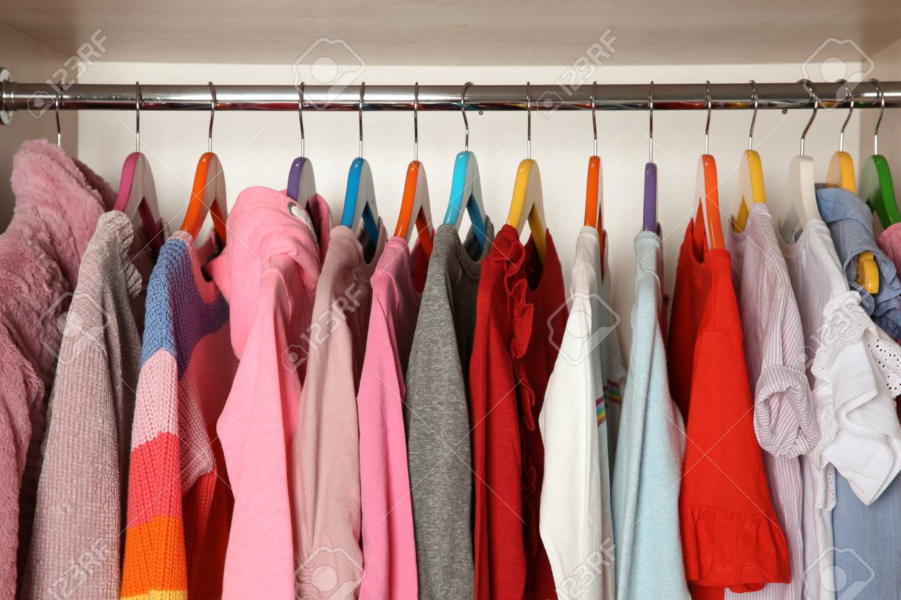 Wardrobe With Stylish Girl S Clothes Hanging On Rack Stock Photo